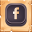 Icono Facebook con relieve marrón oscuro sobre una madera